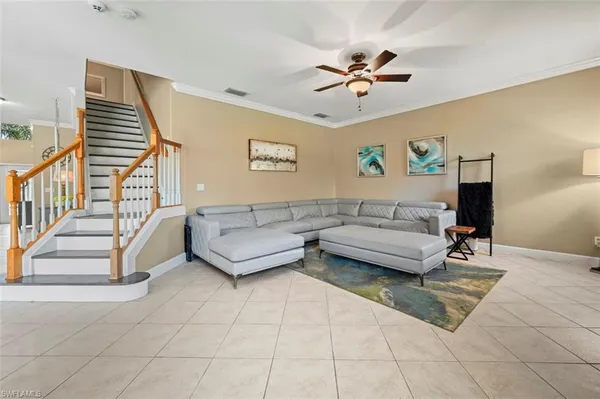a bed room with a bed mirror and a chair