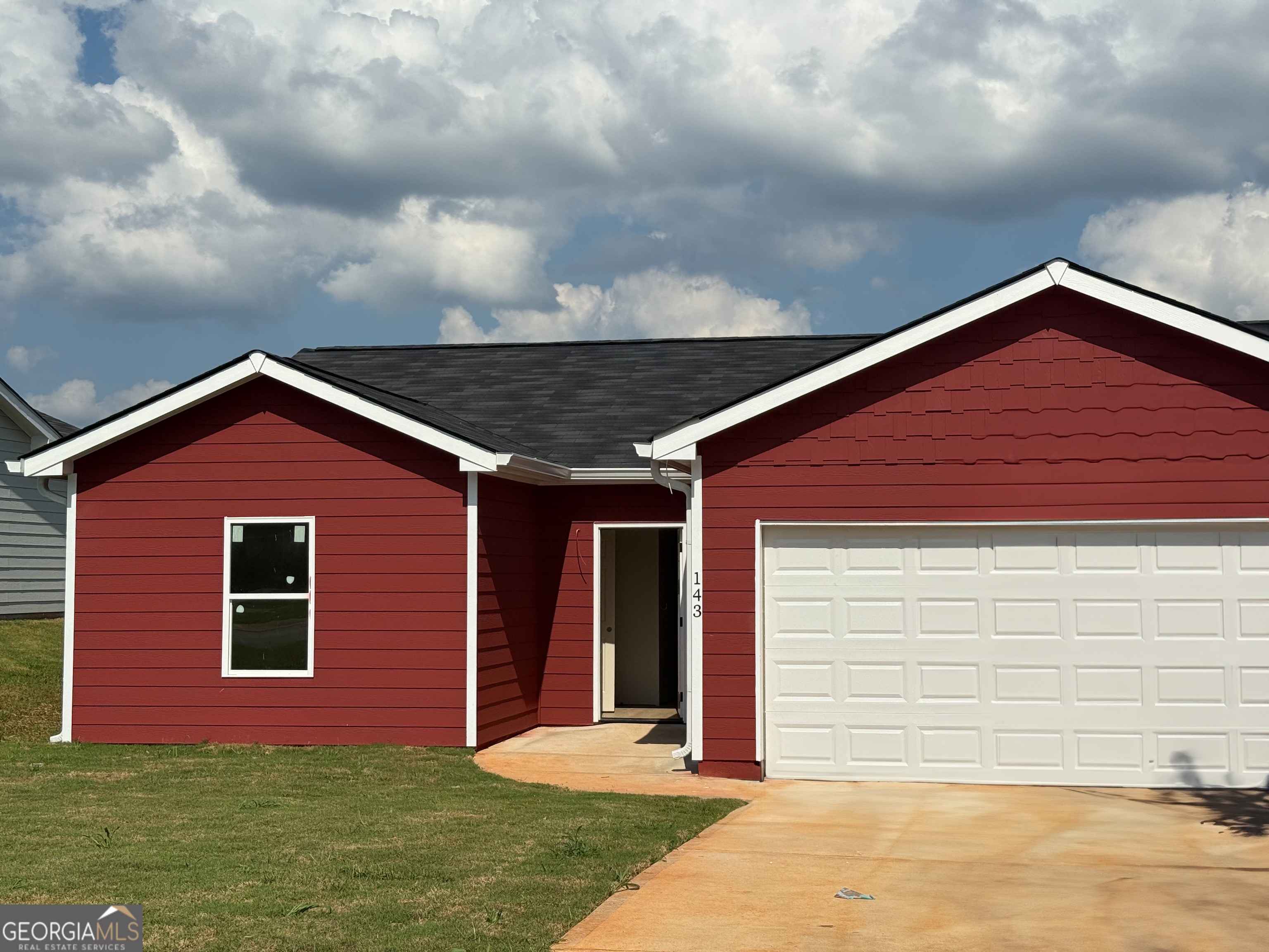 a front view of a house with garden