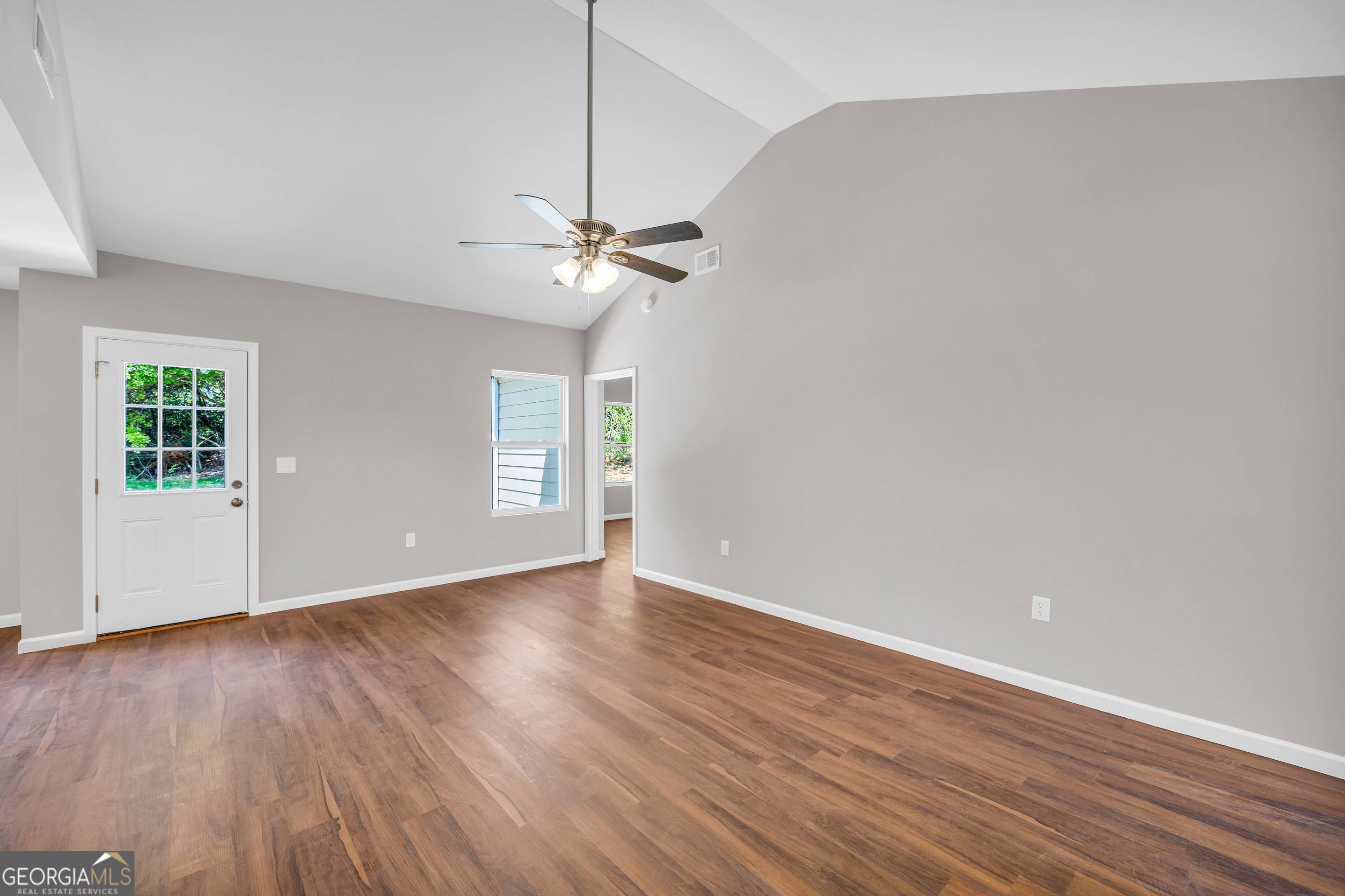 143 ADALINE Court Carnesville, GA 30521 - Photo 12 of 19 a view of an empty room with wooden floor and a ceiling fan