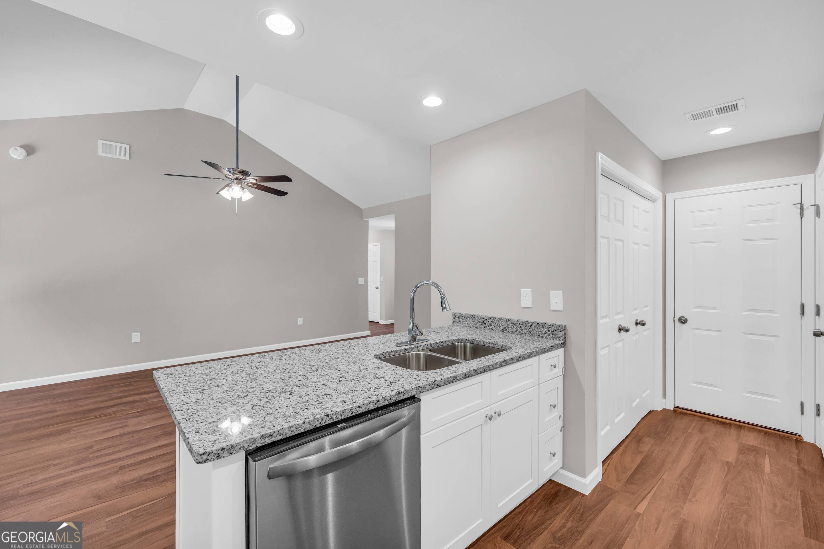 143 ADALINE Court Carnesville, GA 30521 - Photo 17 of 19 a kitchen with stainless steel appliances granite countertop a sink and a wooden floor