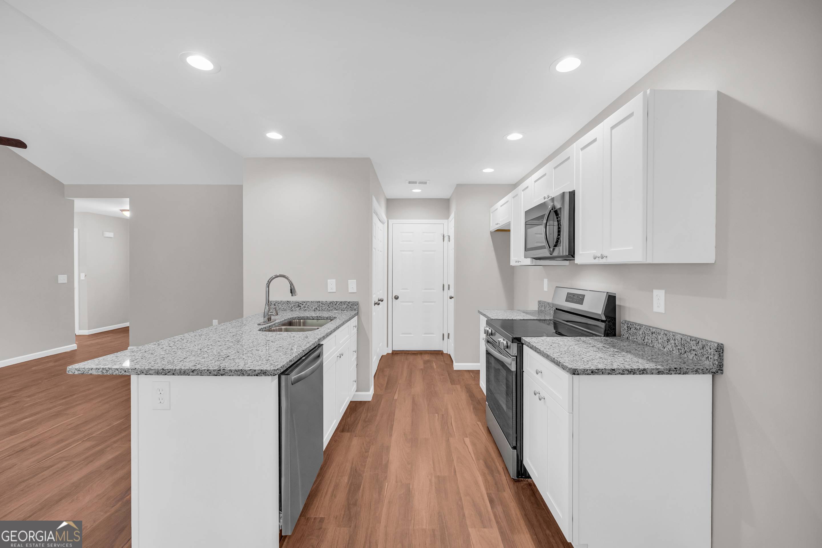 143 ADALINE Court Carnesville, GA 30521 - Photo 18 of 19 a kitchen with granite countertop a sink a counter top space stainless steel appliances and cabinets