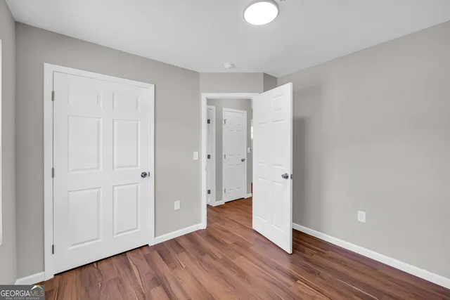 a view of an empty room and wooden floor