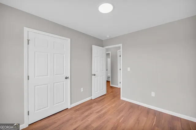 a view of an empty room and wooden floor