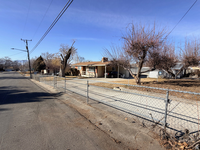 359 East 8400th Street South Sandy, UT 84070 - Photo 35 of 35 View from east side of the home showing the rolling front gate.