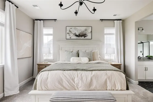 a bed sitting in a bedroom next to a window