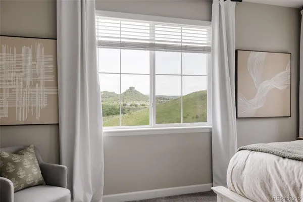 a view of a bedroom with furniture and a window