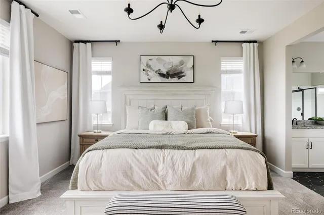 a view of a bedroom with furniture and a window