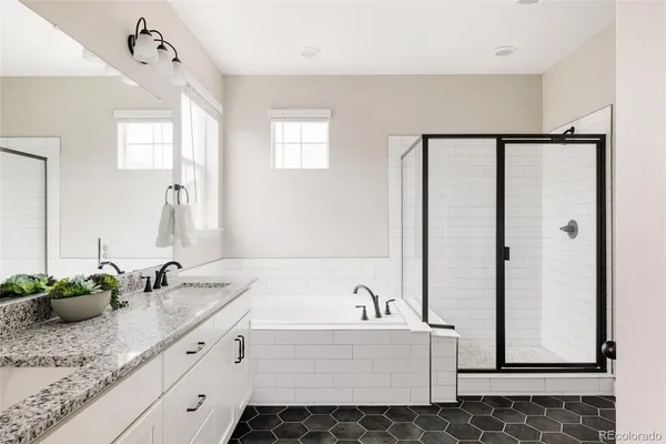 a bathroom with a tub sink and mirror