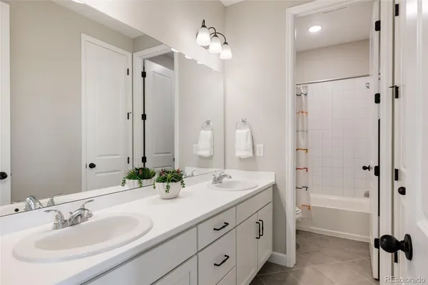 a bathroom with a double vanity sink mirror and double