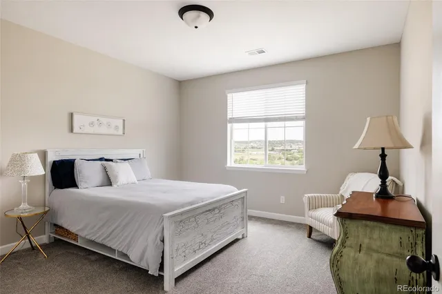 a bedroom with a bed and a lamp