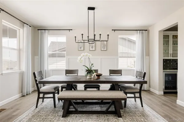a view of a dining room with furniture window and wooden floor