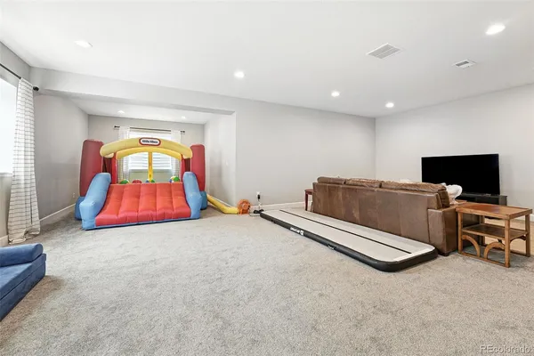 a living room with furniture and flat screen tv