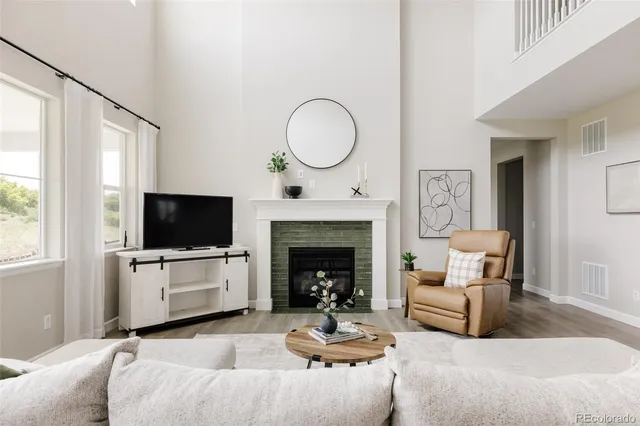 a living room with furniture and a view of kitchen