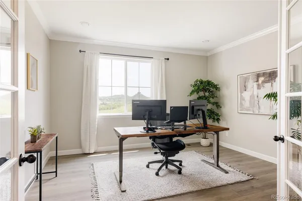 a view of a workspace with furniture and a window