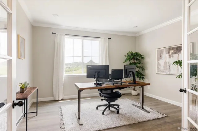 a spacious bedroom with a bed and a flat screen tv