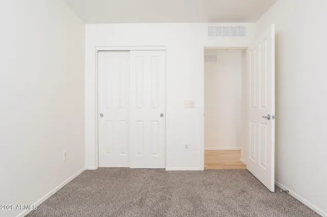 a view of a room with furniture and wooden floor