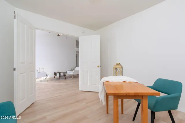 a view of a room that has a table and chair