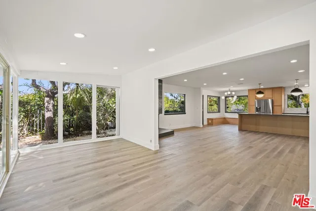 an empty room with wooden floor and fireplace