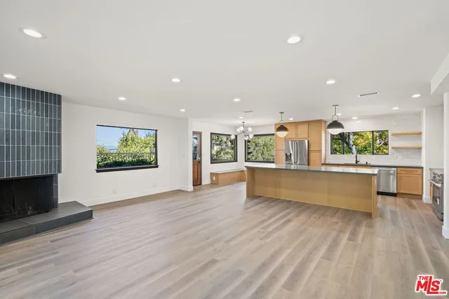 a large white kitchen with a large window