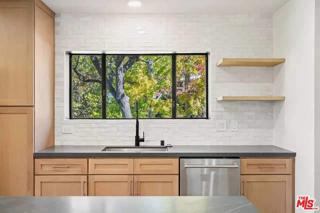 a view of open kitchen with wooden floor and window