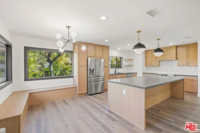 a kitchen with stainless steel appliances a sink and a refrigerator