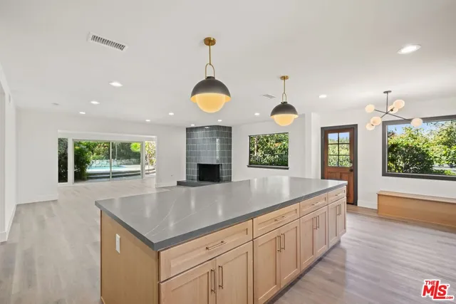 a kitchen with stainless steel appliances granite countertop sink stove and refrigerator
