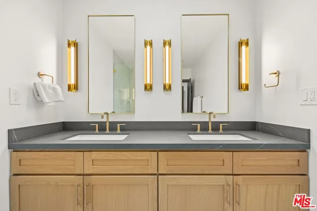 a spacious bathroom with a granite countertop sink mirror and a bathtub