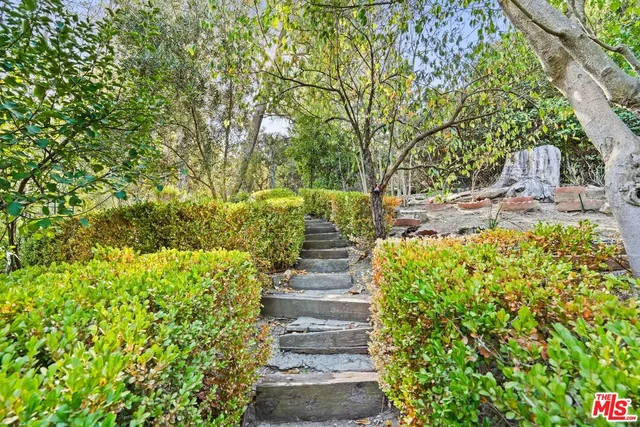 a pathway of a house with a yard