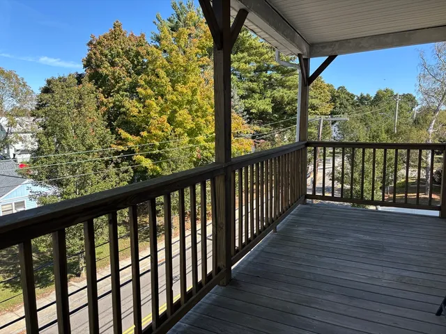 a view of balcony with wooden floor