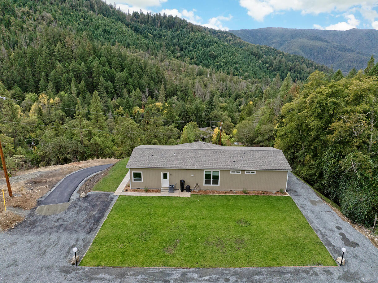 5572 Jumpoff Joe Creek Road Grants Pass, OR 97526 - Photo 21 of 38 a view of a house with a yard