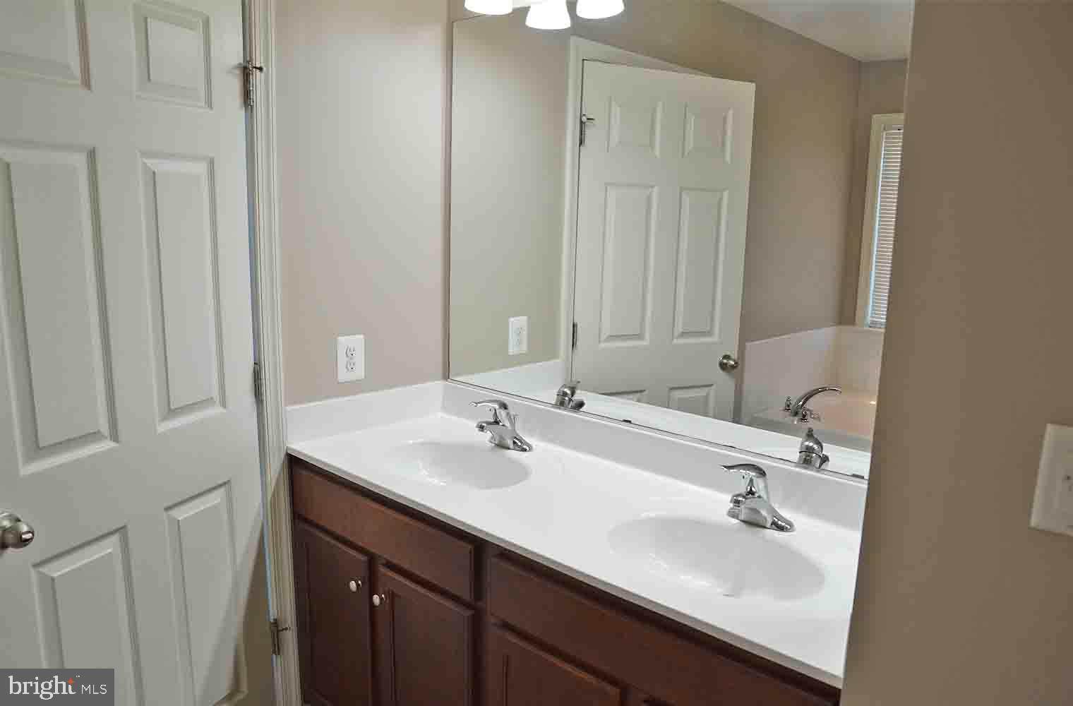 167 Bouldin Road Charles Town, WV 25414 - Photo 13 of 30 a bathroom with 2 sink and a mirror
