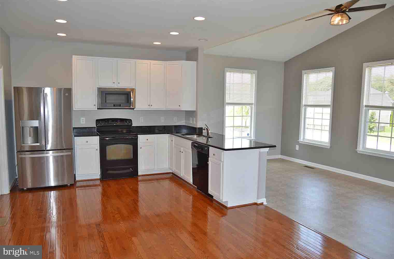 167 Bouldin Road Charles Town, WV 25414 - Photo 3 of 30 a kitchen with stainless steel appliances a refrigerator a stove top oven and sink