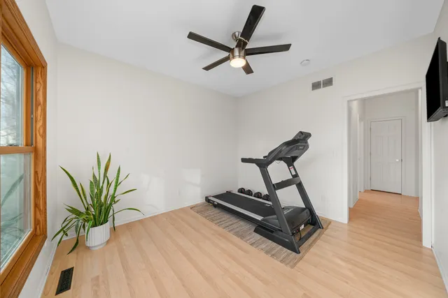 a view of a livingroom with hardwood floor and a ceiling fan