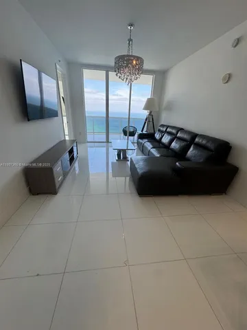 a room with a couch and a view of living room
