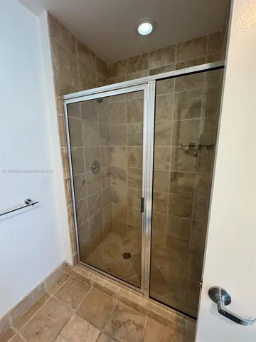 a bathroom with a shower and a sink