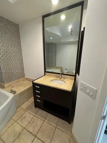 a bathroom with a sink and a mirror