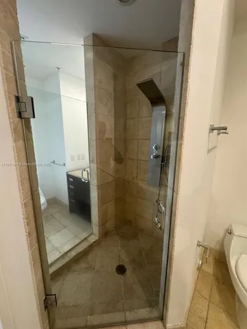 a bathroom with a shower and toilet