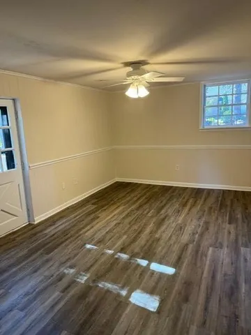 a view of a room with wooden floor and window
