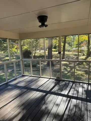 a view of porch with a floor to ceiling window next to a yard