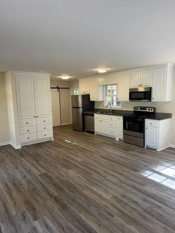 a kitchen with stainless steel appliances a refrigerator and a stove top oven