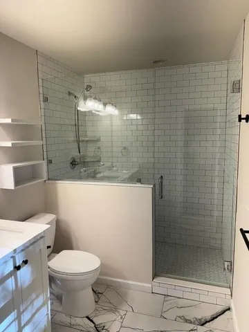 a bathroom with a shower and toilet