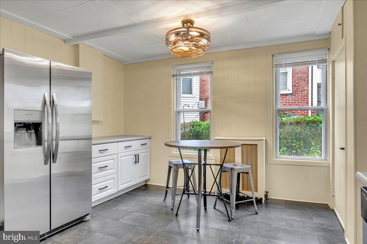 208 8th Street Brookhaven, PA 19015 - Photo 12 of 31 a kitchen with stainless steel appliances kitchen island granite countertop a refrigerator a stove a dining table and chairs with wooden floor