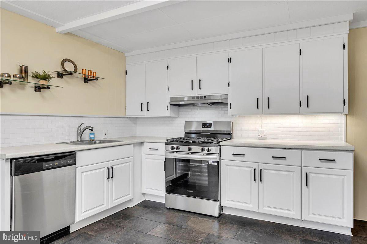 208 8th Street Brookhaven, PA 19015 - Photo 2 of 31 a kitchen with white cabinets and white appliances