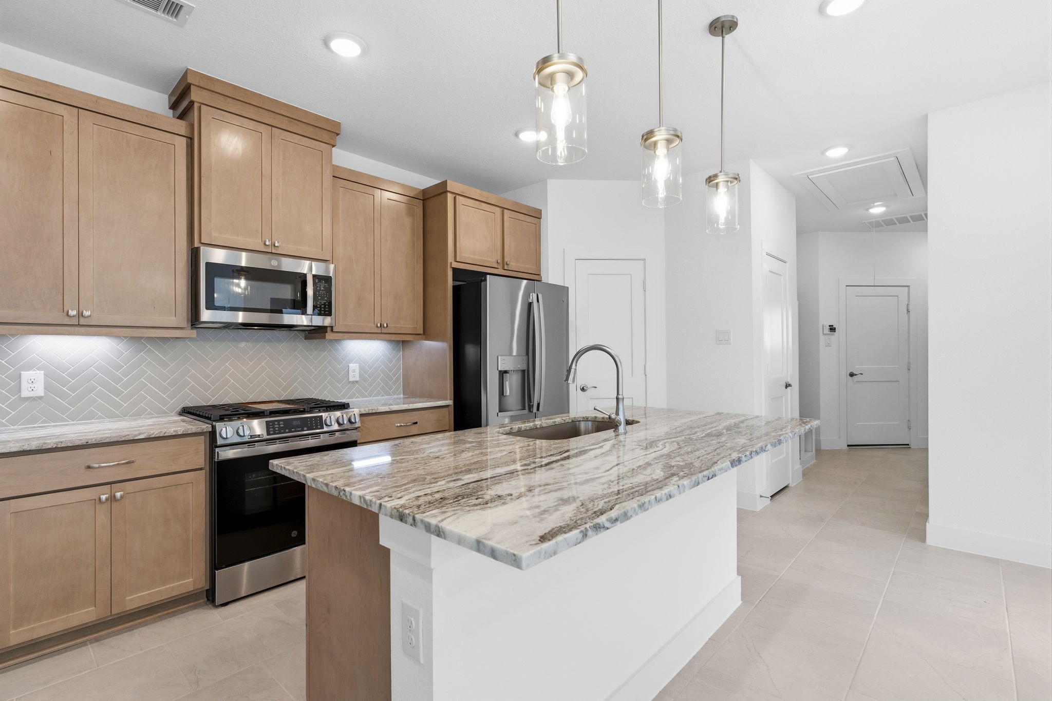 5251 Celestial Court Rosharon, TX 77583 - Photo 16 of 46 a kitchen with stainless steel appliances granite countertop a stove a sink and a refrigerator