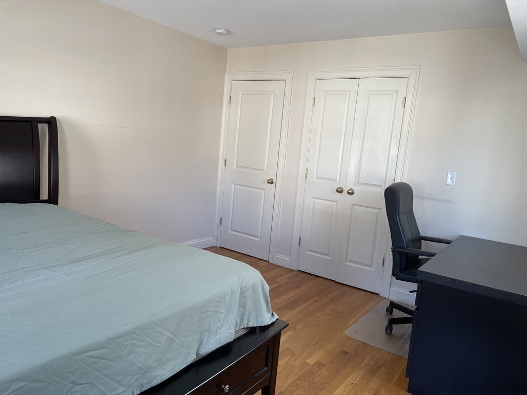 220 Grove Street, Unit 1 Waltham, MA 02453 - Photo 18 of 34 a bedroom with a workspace