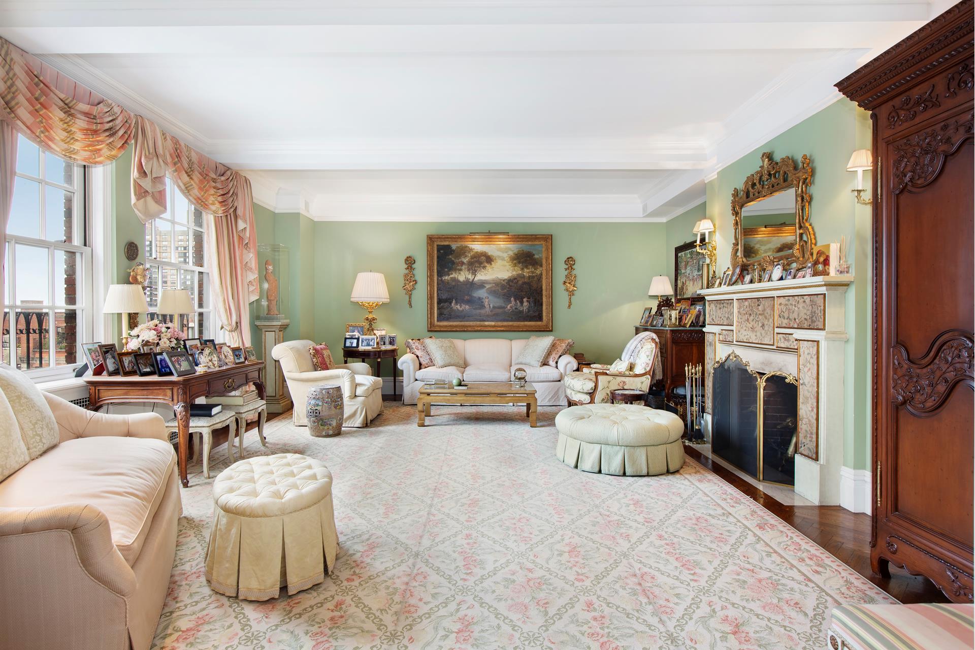 a living room with furniture a fireplace and a large window