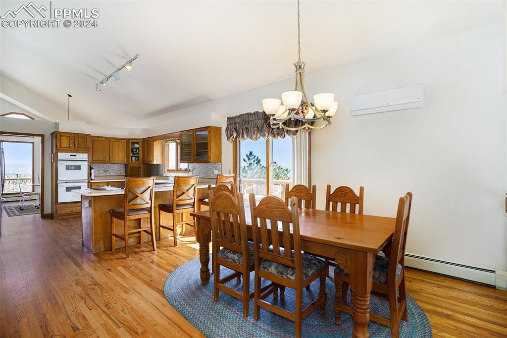 4315 Star Ranch Road Colorado Springs, CO 80906 - Photo 12 of 47 a view of a dining room with furniture and wooden floor
