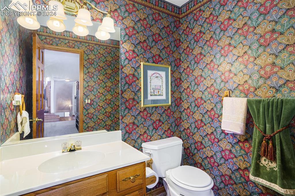 4315 Star Ranch Road Colorado Springs, CO 80906 - Photo 22 of 47 a bathroom with a sink a toilet and a mirror