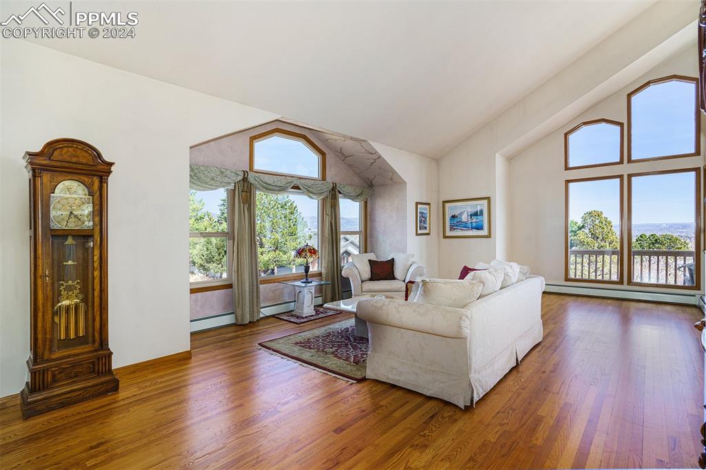 4315 Star Ranch Road Colorado Springs, CO 80906 - Photo 3 of 47 a living room with furniture large window and wooden floor