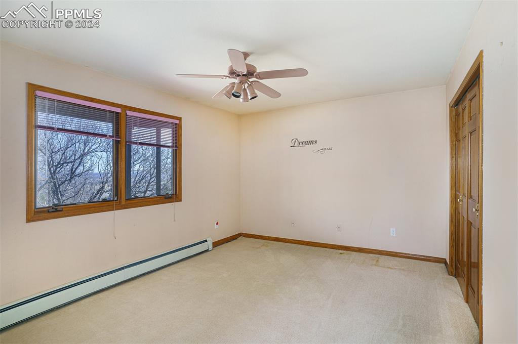 4315 Star Ranch Road Colorado Springs, CO 80906 - Photo 34 of 47 an empty room with windows and fan